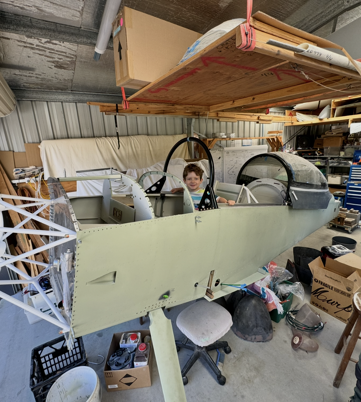 A young Henry Woodward sitting in the cockpit of his first aircraft